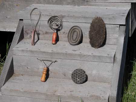 Photo of the various tools used in grooming displayed on two wooden steps.